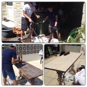 Father and son refurbishing and tiling the old garden table to better weather the elements